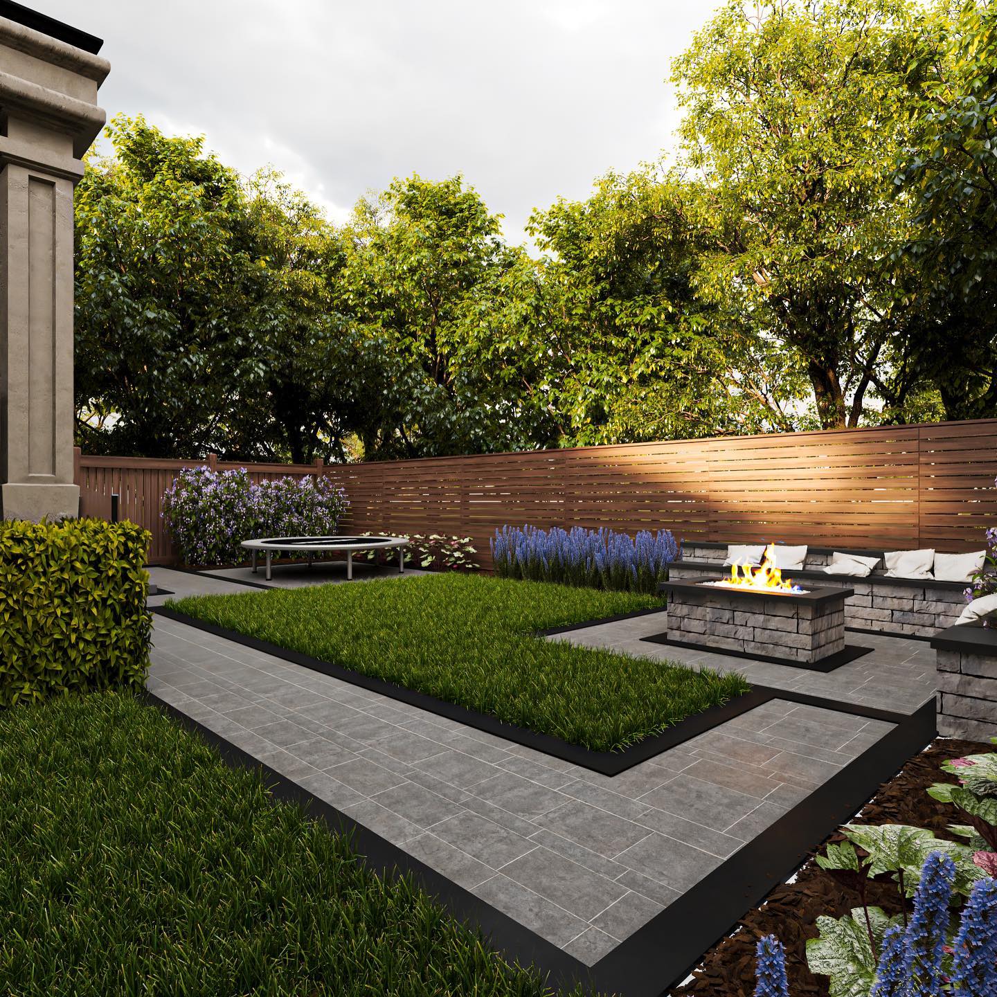 Modern backyard with a tiled pathway, lush greenery, wooden fence, and a cozy fire pit seating area amid vibrant plants and trees.